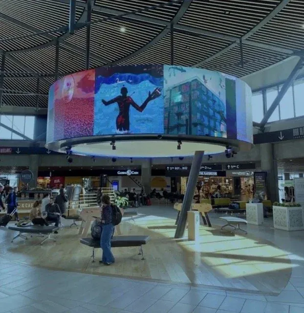 Digital art on a circular screen in an airport terminal, International Women's Day 2022