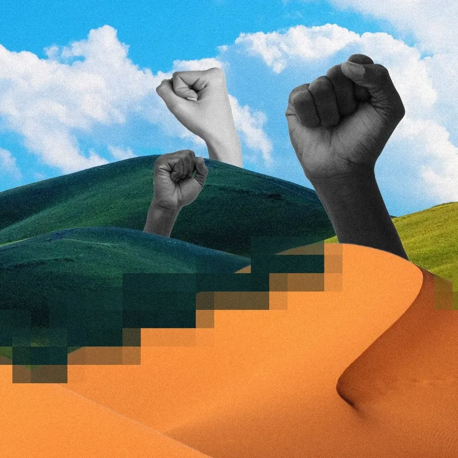 Raised fists rising from desert dunes